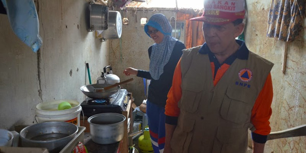 Gubernur Sulut Dr S H Sarundajang saat menyiapkan makanan di posko Tagana untuk para warga korban bencana yang saat ini masih mengungsi