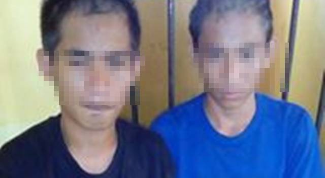 Dua tersangka D dan DP saat digelandang oleh Tim Buser Polsek Mapanget (foto IST)