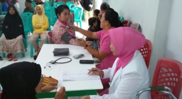 Pengobatan gratis bagi masyarakat Kema III. Tampak Ketua Bhayangkari Minut Linda Pattiwael Libranta, ikut memeriksakan kesehatan.(foto: Polres Minut)